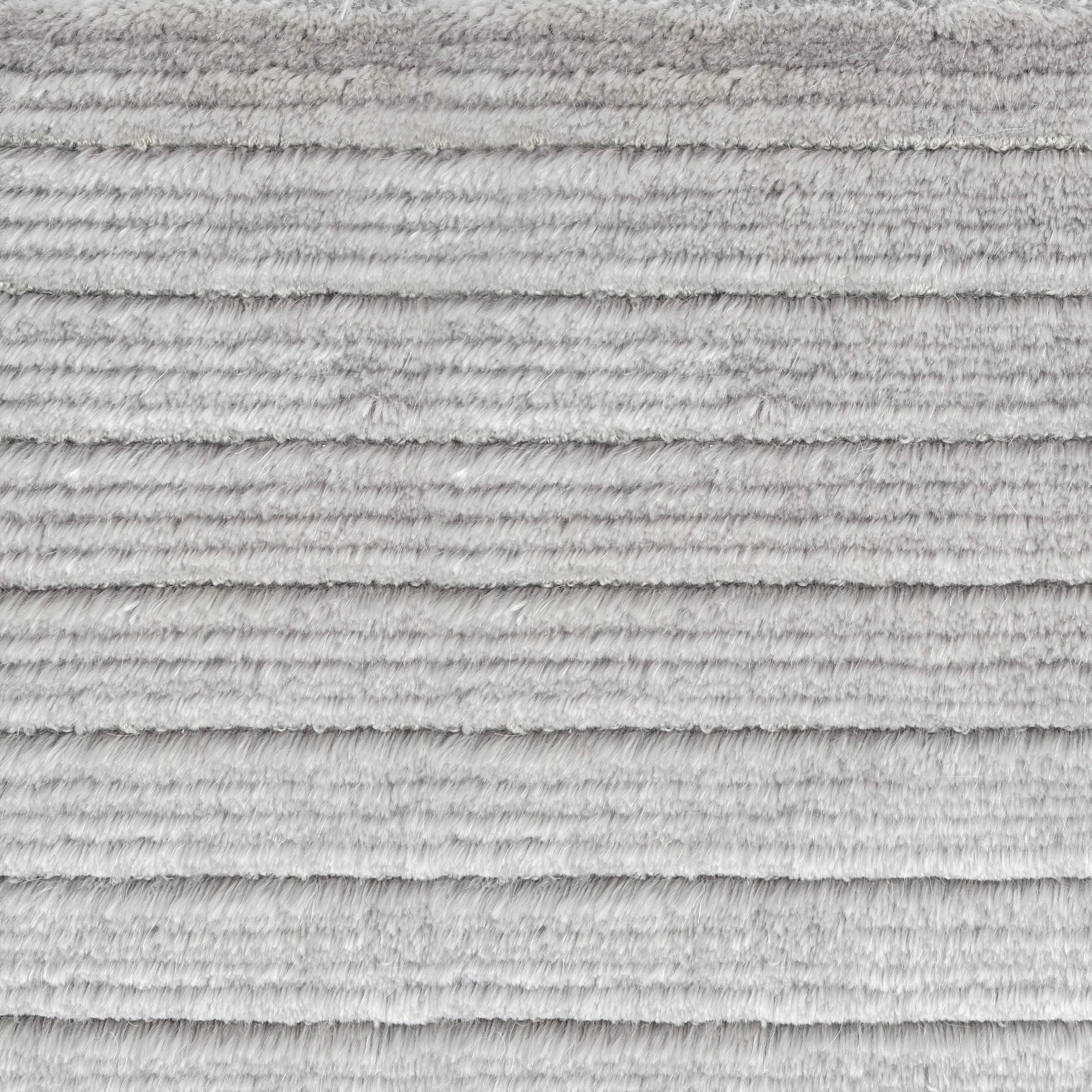 Detail of a handknotted rug in a cut pile stripe in ivory mohair.