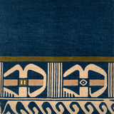 Close-up of a blue carpet with beige geometric patterns