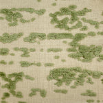 Textured flatweave rug with green pattern on a beige background
