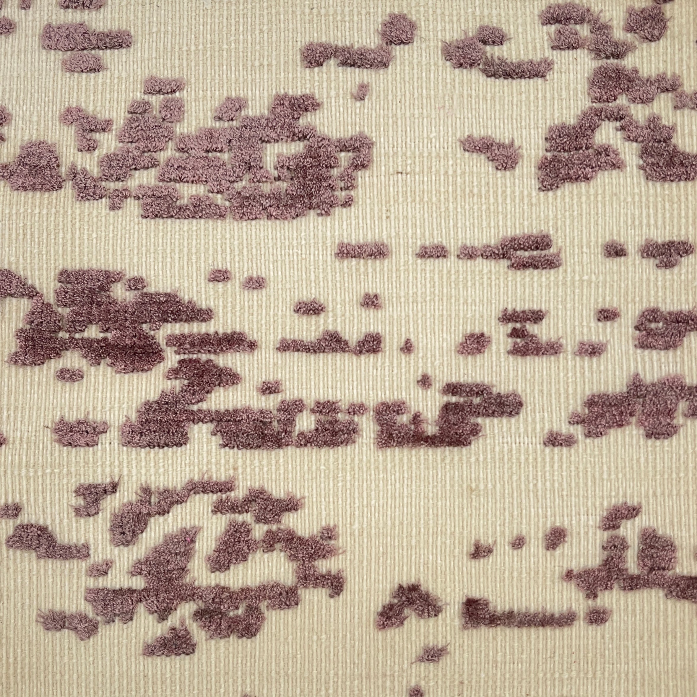Textured fabric rug pattern with purple and beige colors