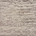 Detail of a handknotted in a subtle striated stripe pattern ivory and brown. 