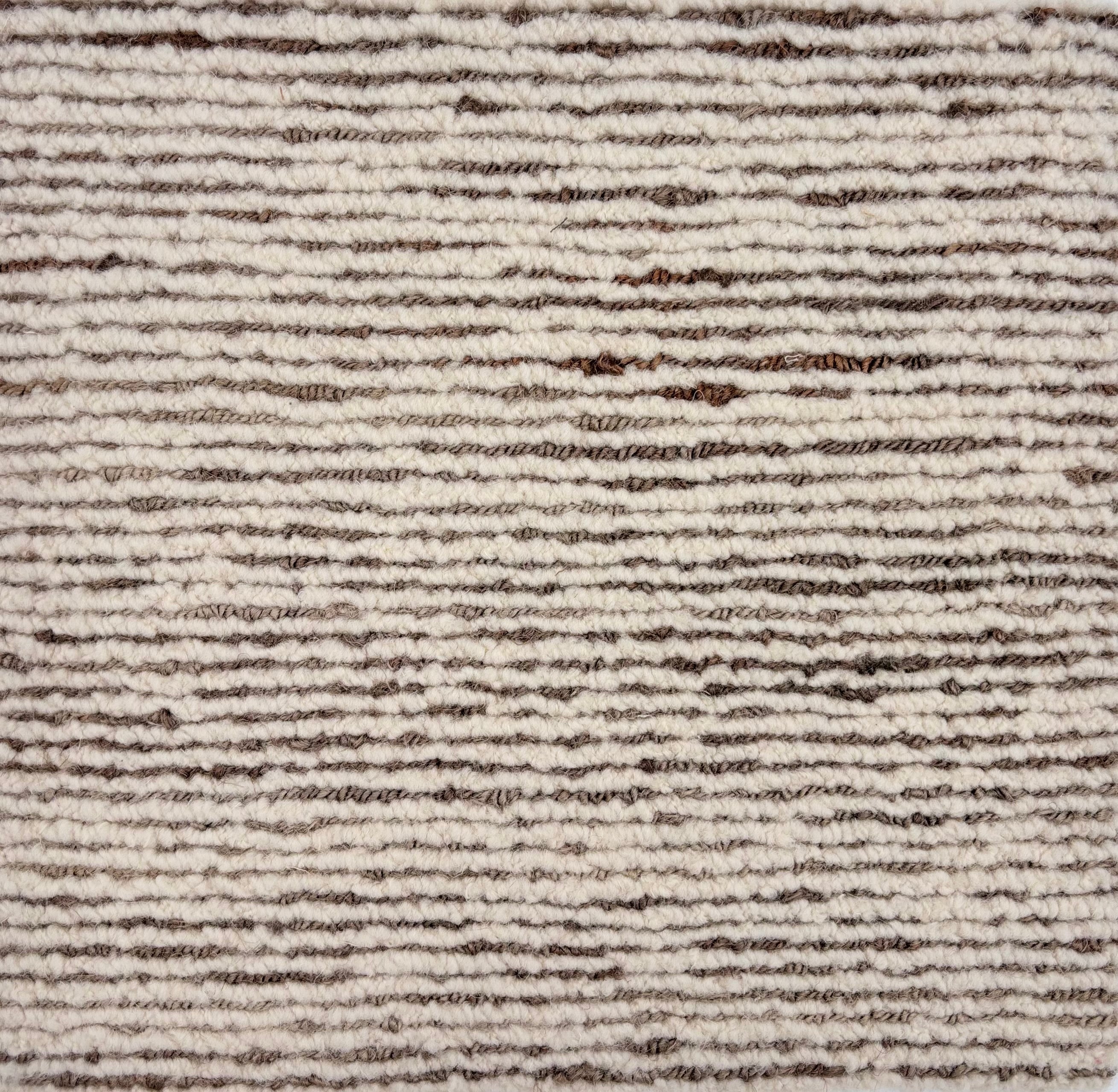 Detail of a handknotted in a subtle striated stripe pattern ivory and brown. 