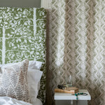 Close-up of a bedroom with a hanging curtain in a diamond grid pattern in olive on a cream field.
