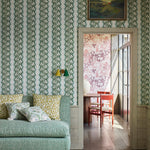 Shabby-chic living room with a statement wall papered in a botanical stripe print in blue, sage and white.