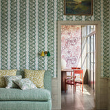 Shabby-chic living room with a statement wall papered in a botanical stripe print in blue, sage and white.