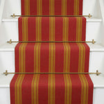 Striped flatweave runner in red and orange on white staircase