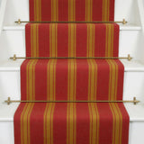 Striped flatweave runner in red and orange on white staircase