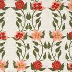 Detail of fabric in a linear floral print in red, orange and green on a white field.