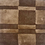 A brown rug with raised pile taupe squares and rectangles.