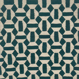 An ivory and deep turquoise rug with a repeating mosaic geometric pattern.