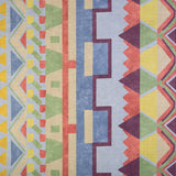 Detail of fabric in a playful geometric stripe in a rainbow of pastel shades.