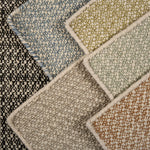 Close-up of various textured carpet samples in different colors.