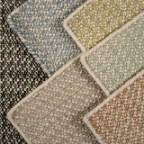 Close-up of various textured carpet samples in different colors.