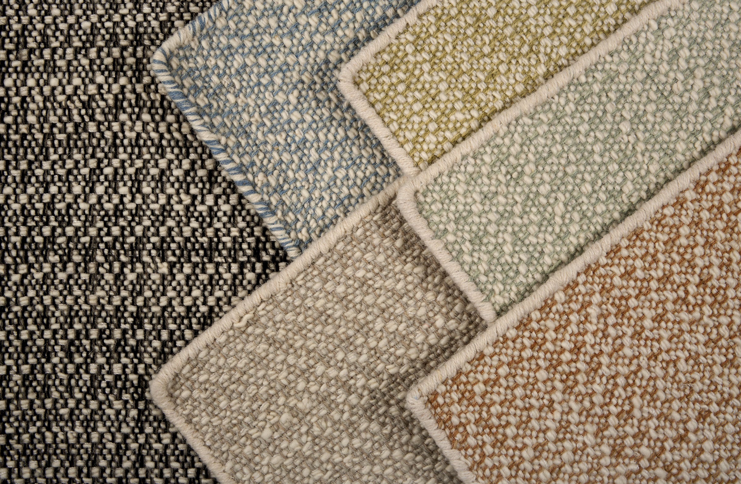 Close-up of various textured carpet samples in different colors.