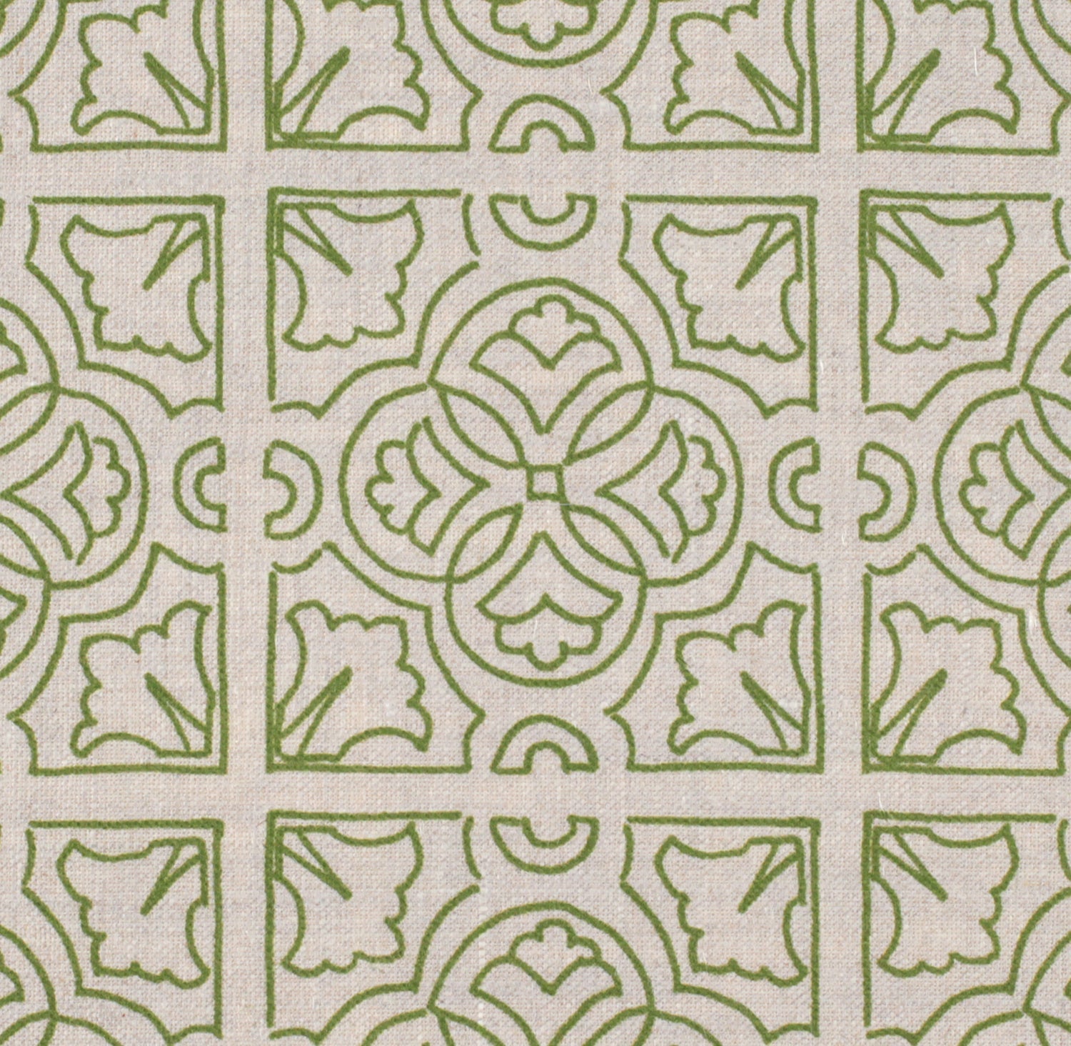 Detail of fabric in a damask lattice print in green on a tan field.