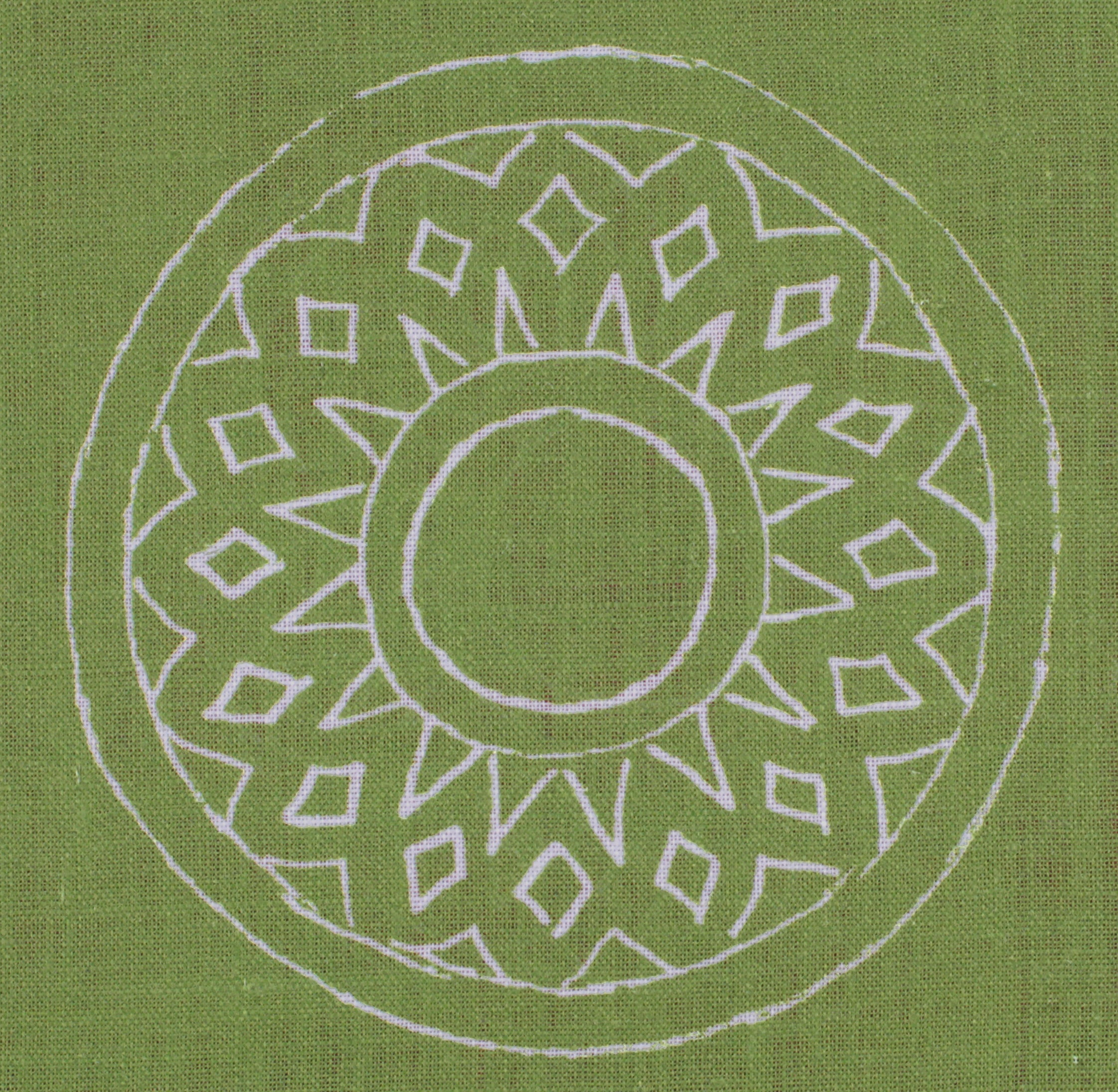 Detail of fabric in a repeating circular geometric print in light gray on a green field.