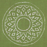 Detail of fabric in a repeating circular geometric print in white on a green field.