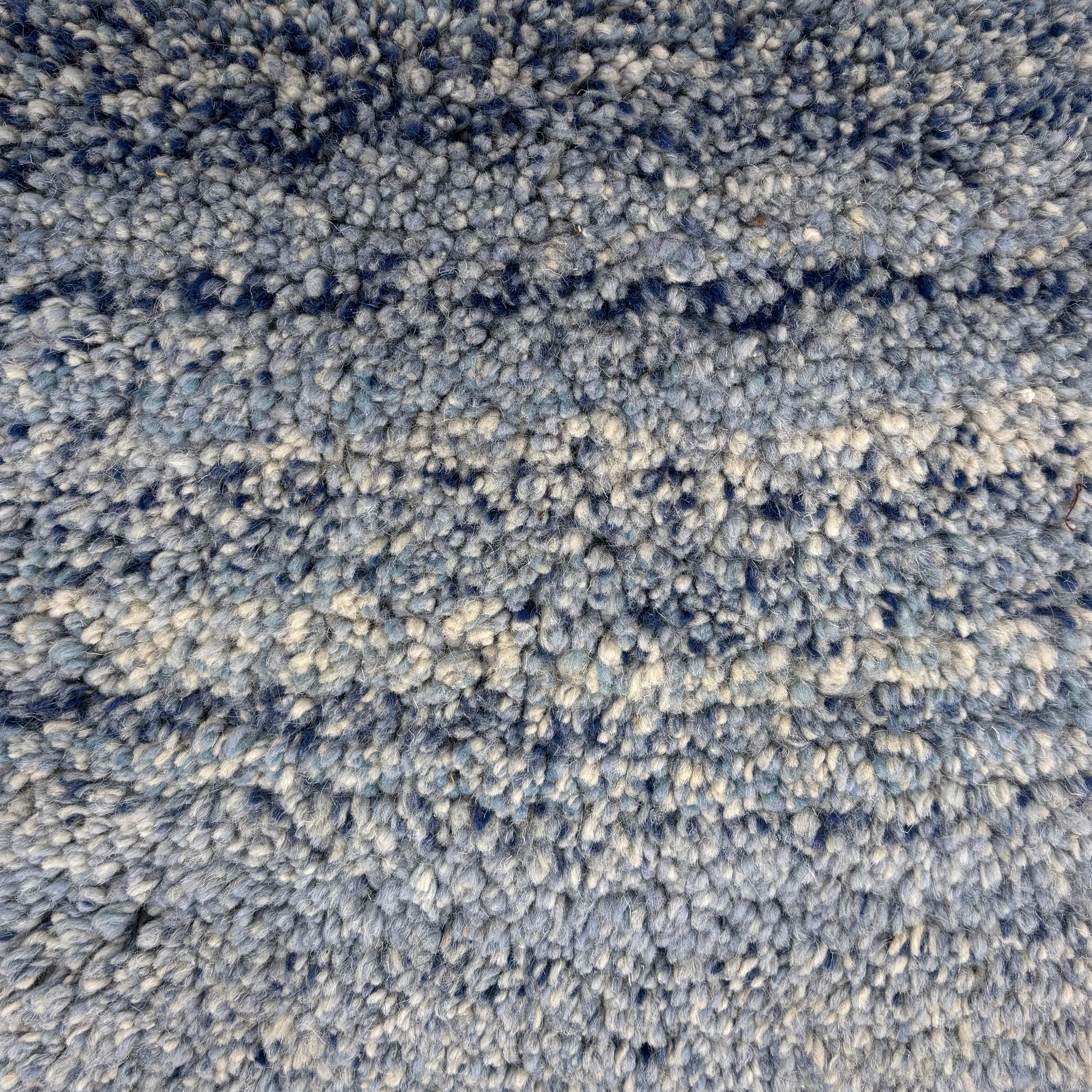 Handknotted cut pile rug in a strie ombre in shades of blue and cream