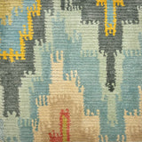 Handknotted rug sample in a ikat flamestitch pattern in blue, grey, ivory, yellow and coral. 