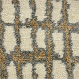 Handknotted rug sample in an abstract textural design in white, grey and tan.