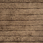 Handknotted rug in a cut pile stripe in brown.