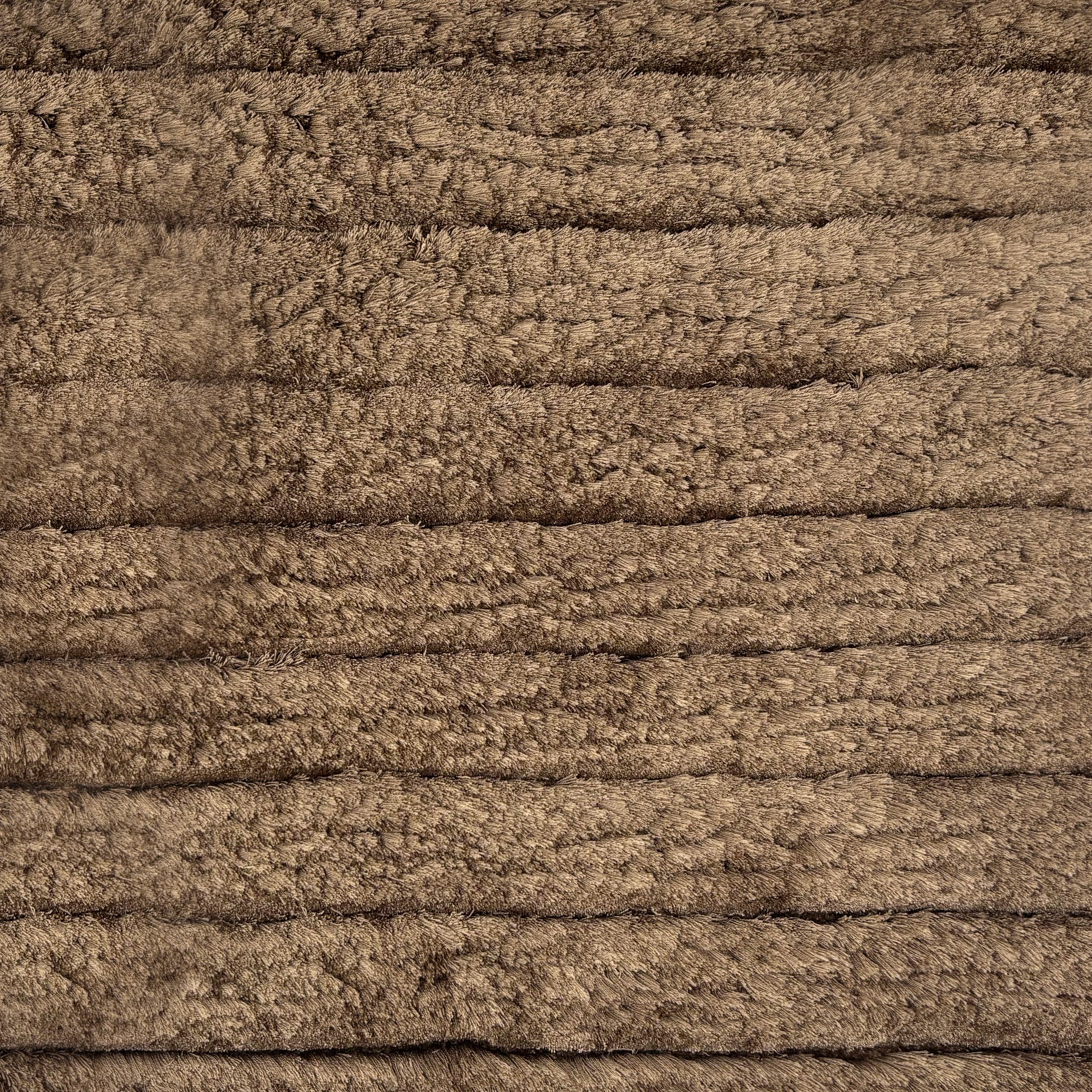 Handknotted rug in a cut pile stripe in brown.