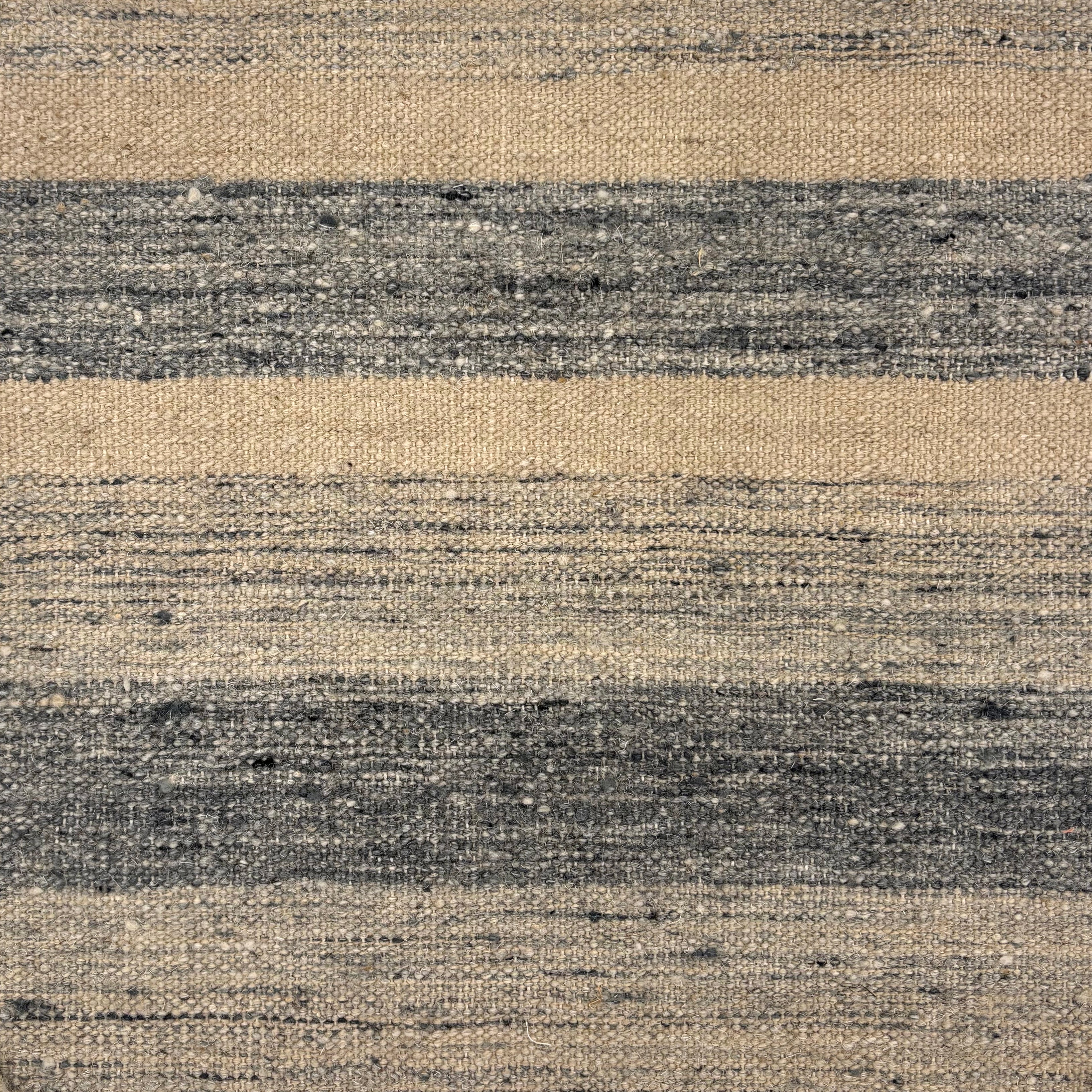 Flatwoven rug in a wide stripe in muted blue with strié cream and navy stripes.