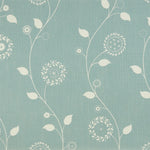 Detail of fabric in a playful floral stripe in white on a light turquoise field.