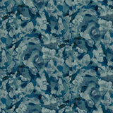 Detail of fabric in an abstract paint print in shades of blue, navy and turquoise.