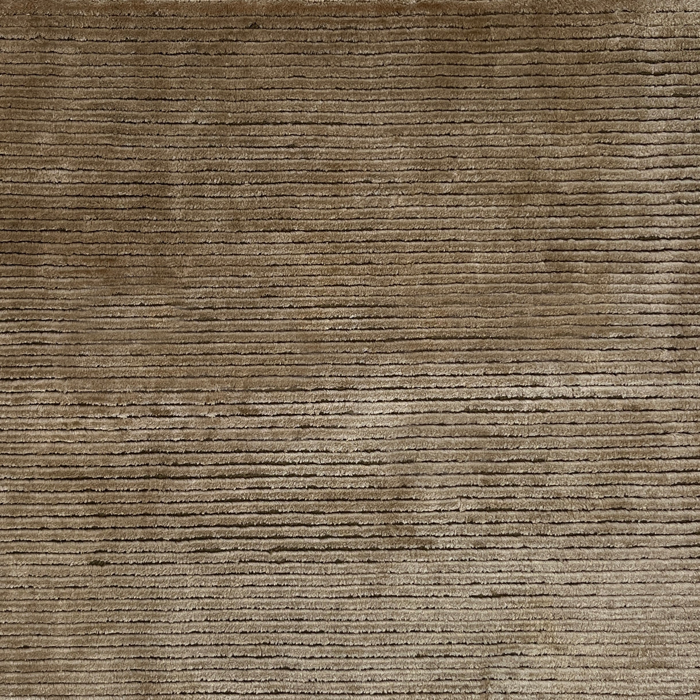 Handknotted cutpile rug in brown.