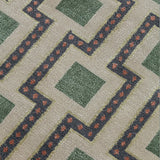 Close-up of a patterned carpet with green squares and red accents.