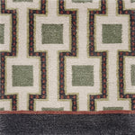 Close-up of a geometric patterned rug with squares and angled lines.