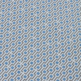 Detail of a wallpaper panel in a geometric grid print in shades of blue and gray.