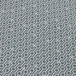 Detail of a wallpaper panel in a geometric grid print in shades of green, blue and gray.