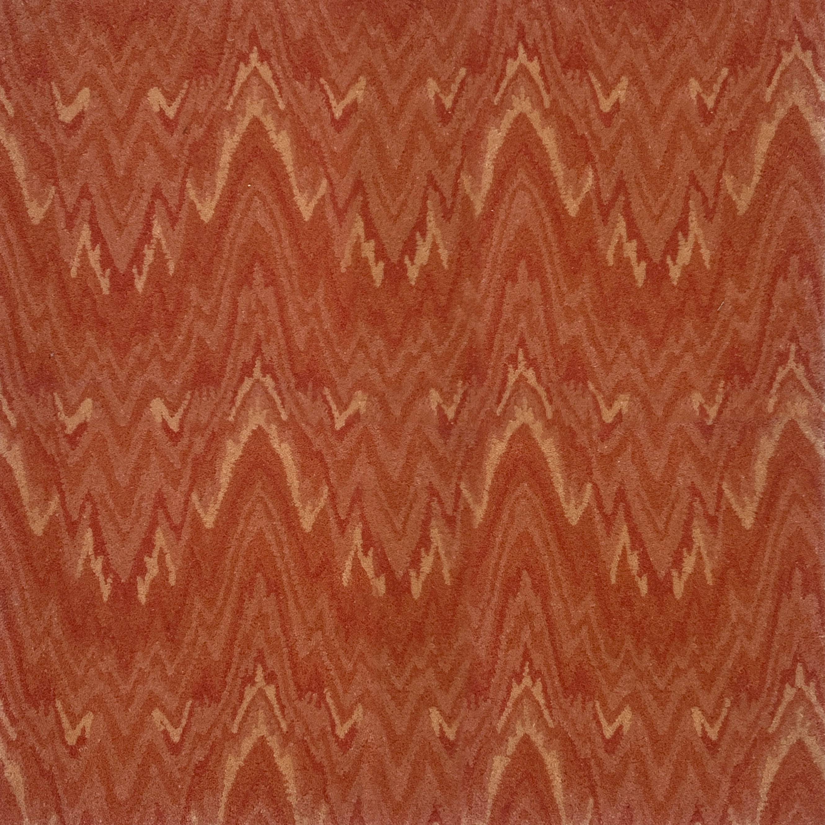 Handknotted rug with wavy lines in shades of red and orange.