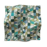 Square fabric swatch in a small-scale playful geometric print in shades of blue, green, white and brown.
