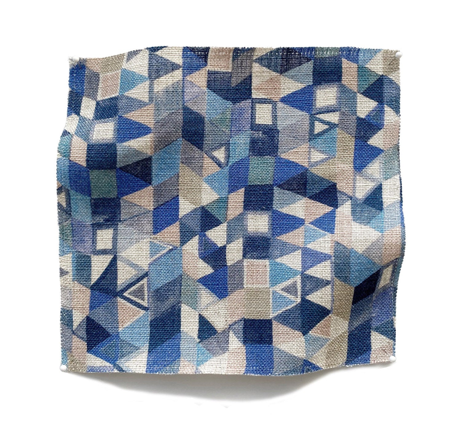 Square fabric swatch in a small-scale playful geometric print in shades of blue, tan and navy.
