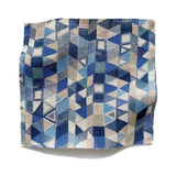 Square fabric swatch in a small-scale playful geometric print in shades of blue, tan and navy.