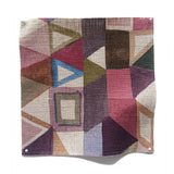Square fabric swatch in a playful repeating geometric print in shades of pink, purple, cream and green.