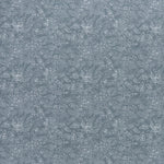 printed linen fabric in a dotted leaf pattern in white on a dusty blue field.