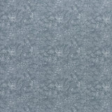 printed linen fabric in a dotted leaf pattern in white on a dusty blue field.