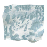 Square fabric swatch in a painterly cloud print in shades of blue-gray on a cream field.