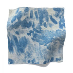 Square fabric swatch in a painterly cloud print in shades of blue and navy on a cream field.