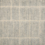 Textured carpet with a checkered pattern in gray and beige tones.