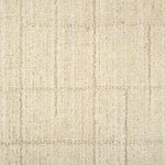 Textured carpet with a checkered pattern in cream tones.