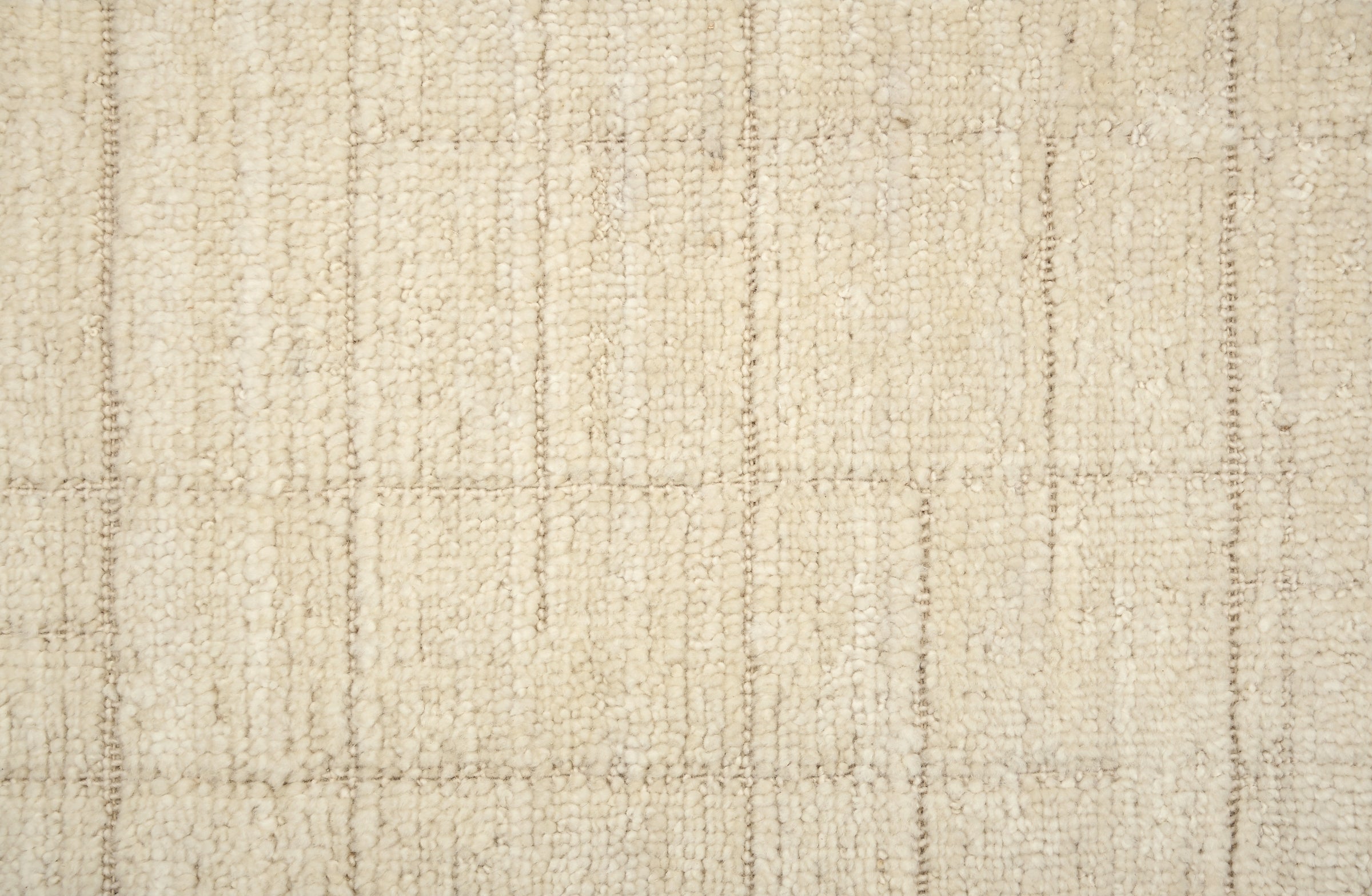 Textured carpet with a checkered pattern in cream tones.
