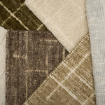 Close-up of textured carpet samples in brown, beige, and gray.