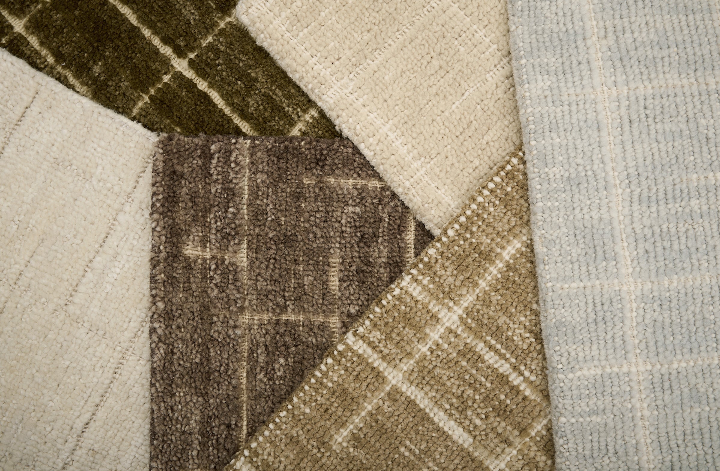 Close-up of textured carpet samples in brown, beige, and gray.