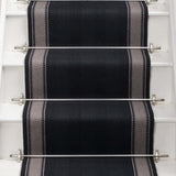 Striped flatweave runner in black and white on white staircase