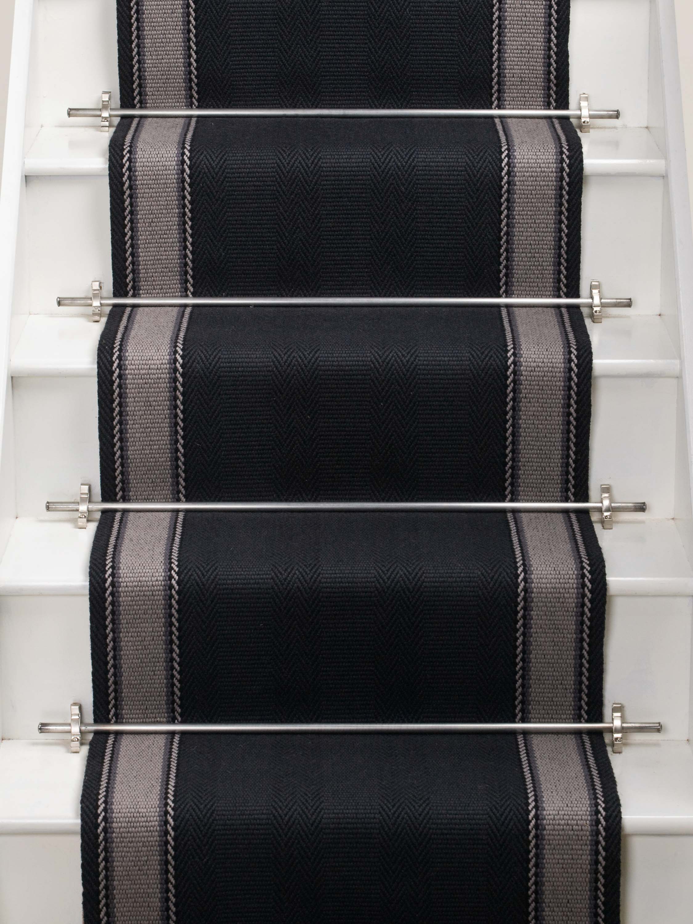 Striped flatweave runner in black and white on white staircase